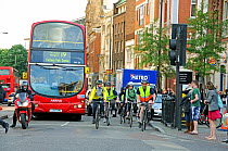 Commuter cyclists and bus in rush hour traffic, Angel, London Borough of Islington, England, UK, May 2009