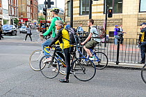 Commuter cyclists held up at traffic lights, Angel, London Borough of Islington, England UK, May 2009