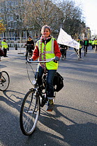 Female cyclist at Climate Change March, London England, UK, December 2008