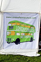 London Permaculture Network on green bus with &#39;Transition&#39; as it&#39;s destination printed on side of tent at London Green Fair (previously Camden Green Fair) England UK, June 2012