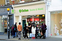 People looking into the window of an Oxfam charity shop Marylebone High Street, London Borough of Westminster, England UK, March 2009