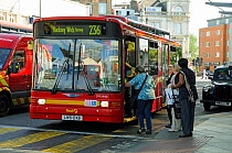 People boarding a single decker bus at Finsbury Park Bus Station, London England UK, September 2009