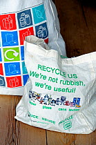 Reusable cotton bags on kitchen table, with images and text promoting &#39;reduce reuse recycle&#39; Holloway, London Borough of Islington