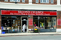 Lady leaving Second Chance, The Charity Shop for Archway Methodist Church, London Borough of Islington, England, UK, September 2010