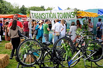 Transition Towns Stall surrounded by people with upsidedown bicycles in front, London Green Fair (previously Camden Green Fair) England UK, June 2011