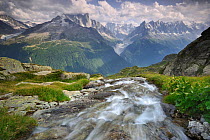 Stream from Lac Blanc with high alpine peaks in the background. Aiguilles Rouges (Red Peaks) nature reserve, Haute-Savoie, Chamonix, France, August 2012.