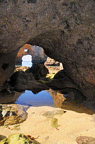 Weathered sandstone cliffs, boulders and natural rock archway carved by the sea. Ponta da Piedade, Lagos, Algarve, Portugal, June 2012.