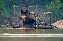 Panning for Gold on the Madre de Dios River in the Peruvian Amazon. The river has the highest levels of mercury pollution of any river worldwide due to the gold mining industry along its banks, Septem...