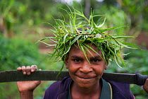 Young boy with plant head dress, in Tari Valley, Southern Highlands, Papua New Guinea. August 2011