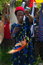 Lady in market with male Raggiana Bird of Paradise (Paradisea raggiana) for sale, Mount Hagen, Papua New Guinea, August 2011