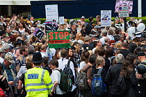 Groups of people and police officer at anti badger cull march, London, 1st June 2013
