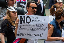 Man holding sign which says 'No to the badger cull, Scientifically fallable, Financially questionable and morally indiffensible' at anti badger cull march, London 1st June 2013