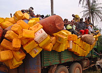 African rainforest penetration and associated pressures. People on truck with water containers. Influx of humans exerts pressure on wildlife and natural resources outside and within protected areas th...