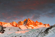 Mountains in snow, Aiguille du Tour with Tower Glacier in front. Sunset with a dark sky. Chamonix, Haute Savoie, France, December 2011