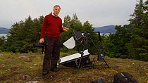 Photographer Niall Benvie talking about the purpose of his portable field studio whilst on assignment for 2020vision, Coigach / Assynt Scottish Wildlife Trust Reserve, Sutherland, Highlands, Scotland,...