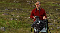 Photographer Niall Benvie using and talking about his portable field studio set up whilst on assignment for 2020vision, Coigach / Assynt Scottish Wildlife Trust Reserve, Sutherland, Highlands, Scotlan...