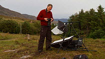 Photographer Niall Benvie setting up his portable field studio whilst on assignment for 2020vision, Coigach / Assynt Scottish Wildlife Trust Reserve, Sutherland, Highlands, Scotland, UK, June 2011. Se...