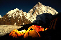 Broad Peak base camp (4,960 m) at night, with K2 (8,611m) and the Godwin-Austen glacier in the background lit by moonlight, Central Karakoram National Park, Pakistan, June 2007. Winner of Photographer...