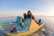 Photographer Steven Kazlowski and his friend in a skiff along the coast during autumn freeze up, Beaufort Sea, off the 1002 area of the Arctic National Wildlife Refuge, North Slope, Alaska