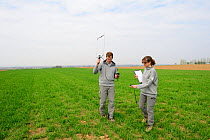 Scientists from the French Wildlife Department (ONCFS) radio tracking common hamsters (Cricetus cricetus) in a wheat field, Alsace, France, April 2013