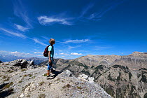 Child looking out over mountains from summit, Queyras, France, August 2011. Model released.
