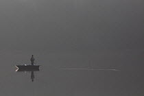 Fisherman on Lake Old Forge, Ardennes, France, November 2011. Model released
