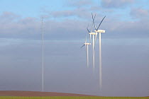 Three wind turbines in clouds, near Picardy, Ribemont, France, December 2011