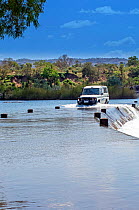 Four-wheel drive car, going across shortcut through river, Ivanhoe Crossing, Kununurra, Western Australia, August 2006
