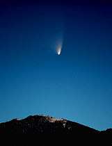 The comet 'PANSTARRS' in transit above the Rocky Mountains, Colorado. March 19, 2013 20:18.  This is a stack of nine images, averaged and then stretched, a common practice in astrophotography, to brin...
