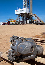 A Mill Tooth drilling bit, in front of a land drilling rig, Lokichar, Kenya, May 2012