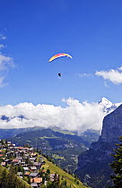 Person paragliding over the village of Murren, Lauterbrunnen Valley, Bernese Oberland, Switzerland, June 2012.