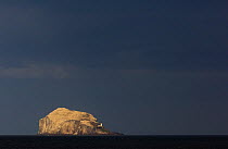 Storm clouds over Bass Rock in the distance, which is the breeding ground for 140,000 gannets, Firth of Forth, Scotland, UK, May