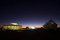 View of a BBC filming camp at night, on location for the Sahara episode of the 'Africa' series, Egypt, September 2011.