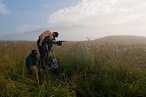 BBC cameramen Justin Maguire and Norbert Rottcher filming flowers using a camera track system for the BBC 'Africa' series, Kitulo Plateau National Park, Tanzania, February 2009.