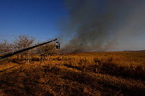Jib arm  with attached camera ready to film an approaching grassland fire for the BBC series 'Africa', South Luangwa National Park, Zambia, July 2011.