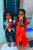 Young girls in Pulicat town with toy dolls, Pulicat Lake, India, January 2013.