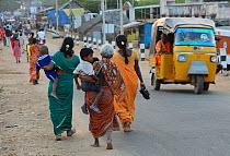 Women carrying children in Pulicat town, Pulicat Lake, Tamil Nadu, India, January 2013.