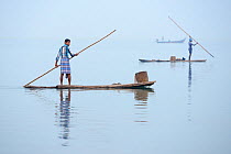 Throw-net fishermen on raft, Pulicat Lake, Tamil Nadu, India, January 2013.