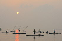 Throw-net fishermen at sunrise, Pulicat Lake, Tamil Nadu, India, January 2013.