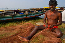 Fisherman mending nets, Pulicat Lake, Tamil Nadu, India, January 2013.
