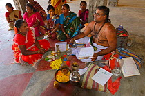 Hindus getting advice from a Swami in the Hindu temple, Pulicat town, Pulicat Lake, Tamil Nadu, India, February 2013.
