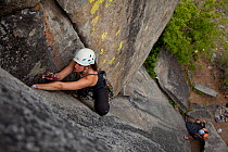 Traditional rock climber places a cam in Poison Ivy Crack, near Leavenworth, Washington, June 2013. Model Released
