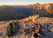 Woman enjoying the summit views at sunset after climbing to the summit of Liberty Bell via the Beckey Route, near Washington Pass in North Cascades, Washington, USA , July 2013