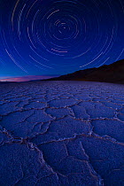 Star trail over Badwater Salt Flats, Death Valley National Park, California. August 2008. Taken with multiple long exposures and fish eye lens.