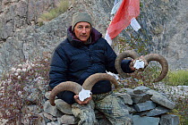 Photographer Eric Dragesco holding male bharal Skulls, (Pseudois nayaur) Hemis NP, at altitude of 3800m, Ladakh, India, October 2012
