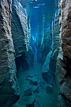 RF- View through narrow Nes Canyon, near Husavik, north west Iceland. May 2011.  Formed by a fault in Iceland's volcanic landscape filled with glacial spring water. (This image may be licensed either...