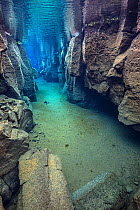 A distant diver explores Nes Canyon, a fault filled with fresh water in the rift valley between the Eurasian and American tectonic plates in northern Iceland.