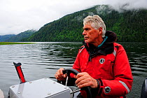 Tom Ellison, founder of the Khutzeymateen Grizzly Bear Sanctuary, at the helm of a boat, British Columbia, Canada, June 2013.