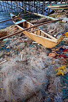 Discarded nets, bangka canoe and other garbage at the beach, Guindacpan Island, Danajon Bank, Central Visayas, Philippines, April 2013