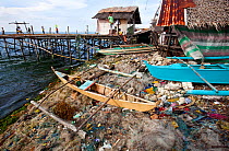 Discarded nets, bangka canoe and other garbage at the beach, Guindacpan Island, Danajon Bank, Central Visayas, Philippines, April 2013
